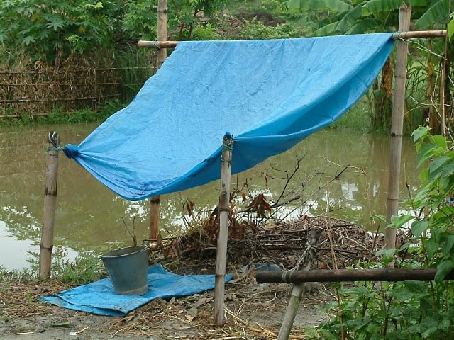 How to Collect Rainwater without Gutters or a Roof  Collecting-rainwater-with-plastic-tarp-tent