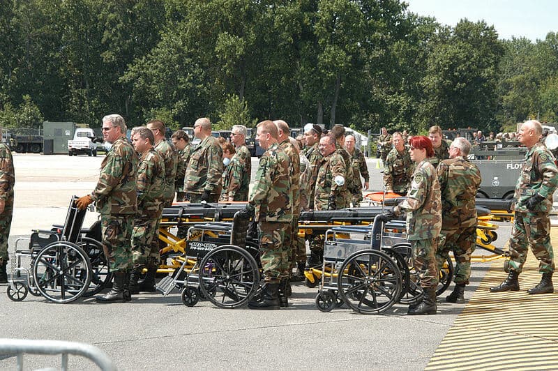 Army and Air Force assisting elderly evacuees from hurricane