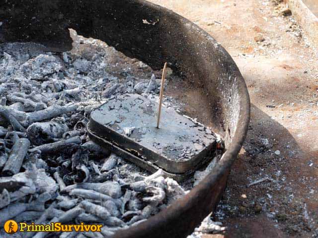 char cloth tin with hole plugged