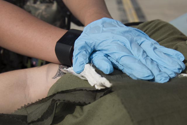 applying pressure to a gunshot wound