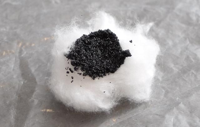activated charcoal spread on a cotton ball