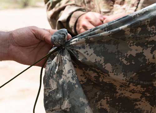 tying tarp with rock trick