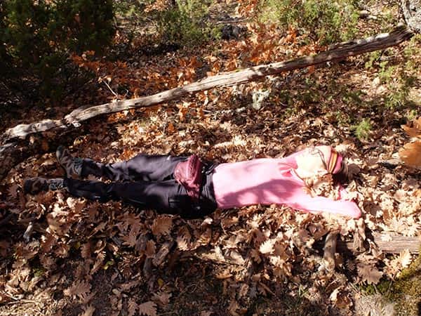 6 add debris on top of bed-min lying on a survival bushcraft raised bed