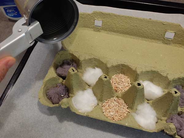 Pouring melted vaseline onto egg carton fire starters